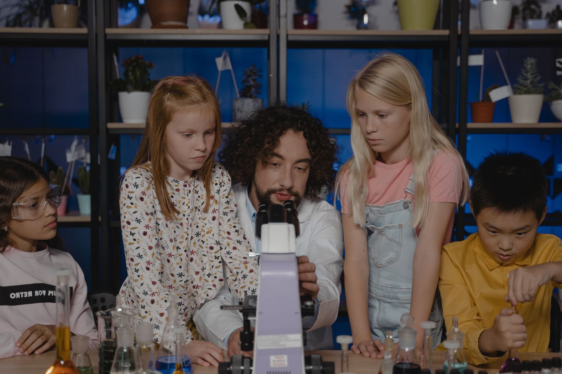 Children and teacher looking at a microscope