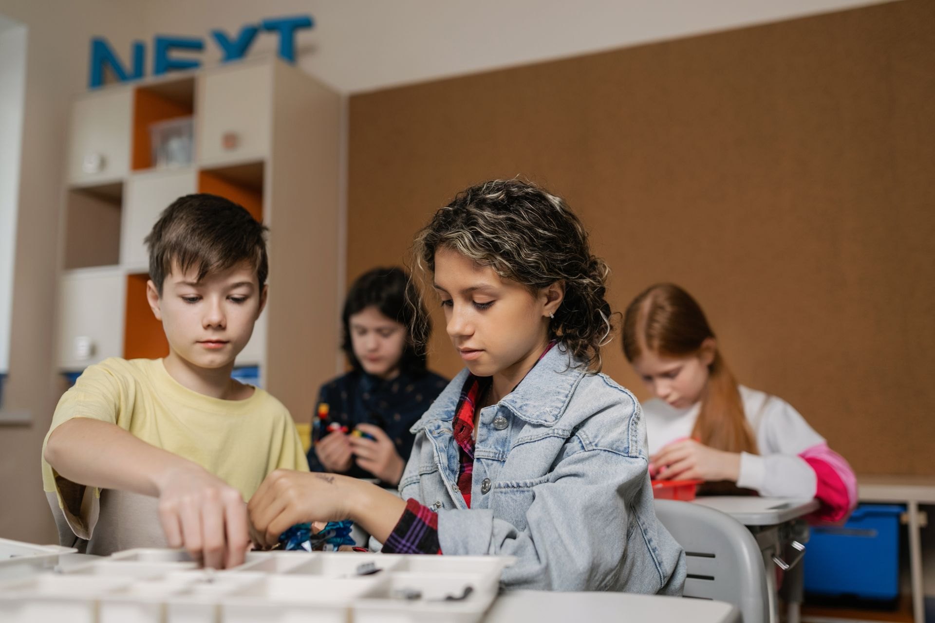 Students assembling a robotics device together in a classroom
