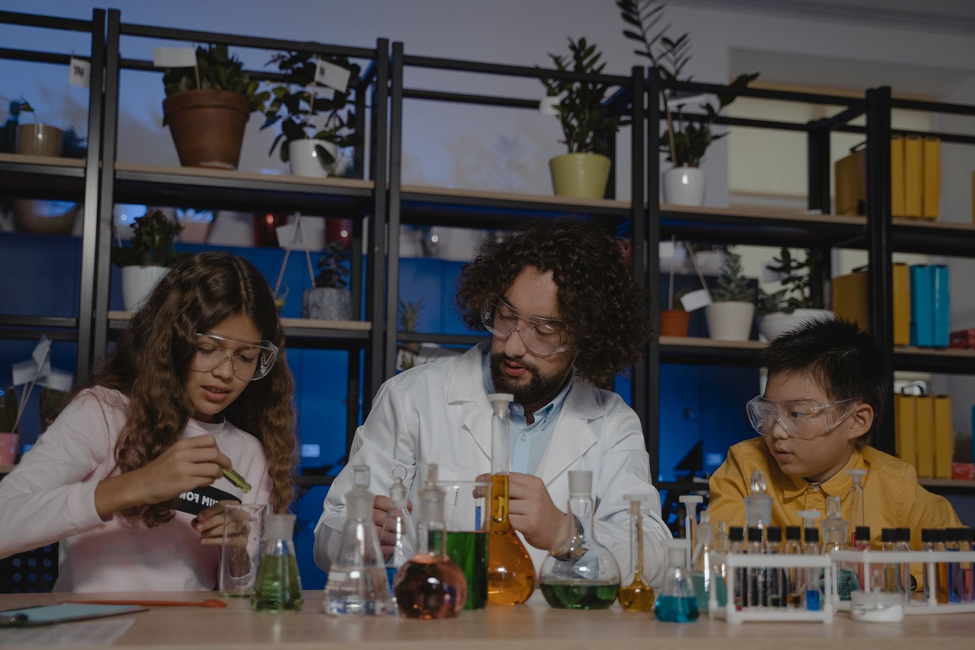 Teacher guiding children through a chemistry experiment